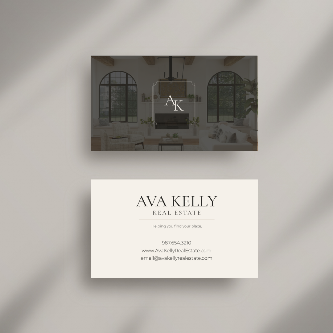 Two real estate business cards displayed on a light gray background with soft diagonal shadows. The top card is dark charcoal with a faint interior room photo and a central monogram logo reading AK.